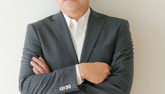 腕を組む40代男性